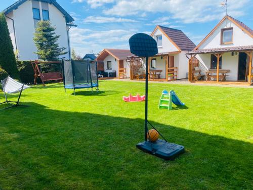 a playground in the yard of a house at DorJan - Domki Letniskowe in Dziwnówek