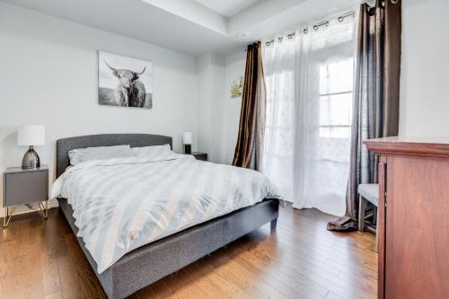 a bedroom with a bed and a window at spacious 3 bedroom space in Markham