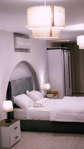 a bedroom with a large white bed with an arch above it at Madina Boutique Hotel in Luxor