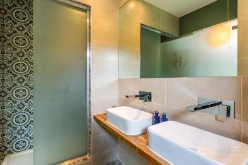 a bathroom with a sink and a mirror at Butt Lodge in Lochranza