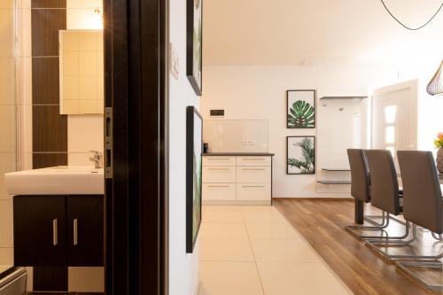 a kitchen with a sink and chairs in a room at Beachfront villa with private pool in Vela Luka in Vela Luka