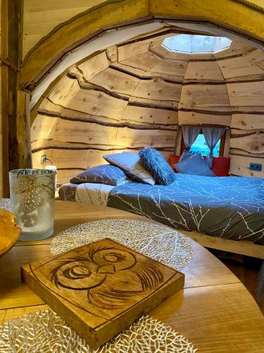 a room with two beds in a log cabin at Les Cabanes De Pyrene in Cazarilh