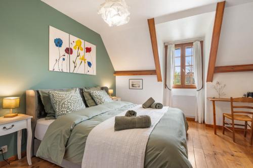 a bedroom with a bed and a couch at L'instant présent in Hautot-lʼAuvray