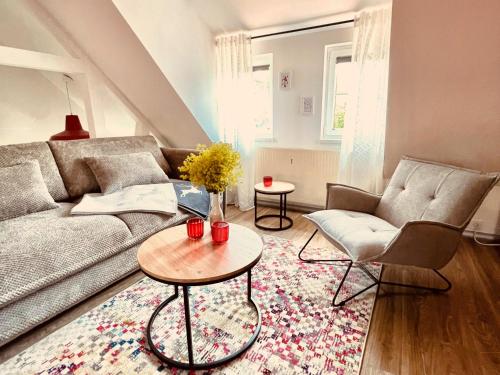 a living room with a couch and a table at Thüringer Wald-Zauber in Zella-Mehlis