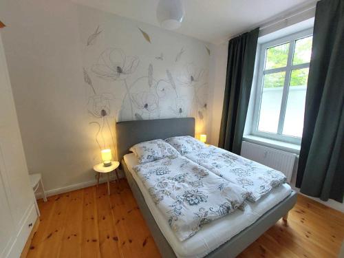 a bedroom with a bed with two candles on it at Historisches Stadthaus Schwentine in Eutin