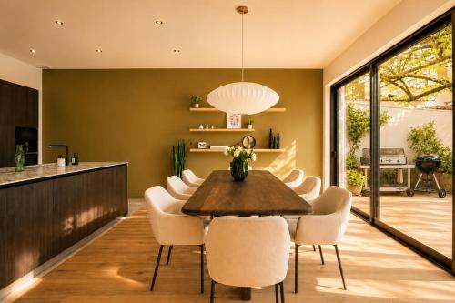 a dining room with a table and chairs at Villa Marie climatisation piscine & jardin Dijon centre in Dijon