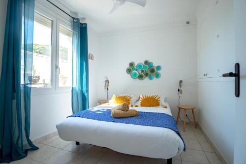 a bedroom with a bed with a towel on it at VILLA LES SALINES Maison de Vacances au Grau du Roi in Le Grau-du-Roi