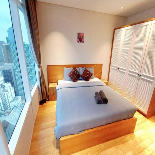 a bedroom with a bed and a large window at vortex klcc by IOI HOME management in Kuala Lumpur