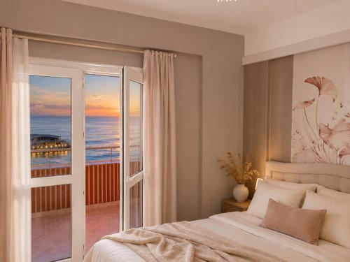a bedroom with a bed and a view of the ocean at Big Center Beachfront Apartment in Durrës