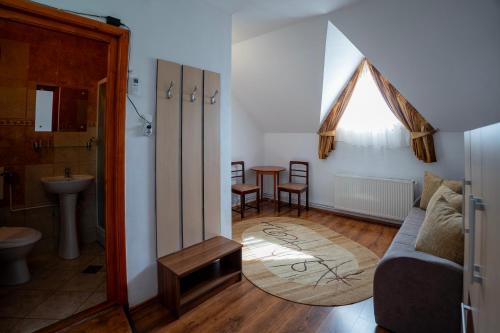 a living room with a couch and a table at Casa Toma in Sovata