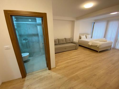 a living room with a couch and a sliding glass door at Venecia gold in Struga