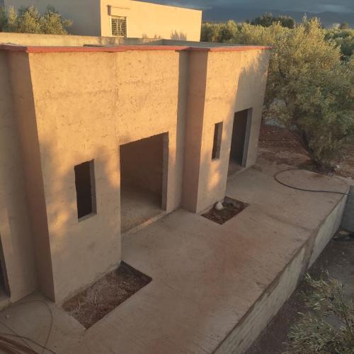 an unfinished house with three doors on the outside at immo in Aghmat
