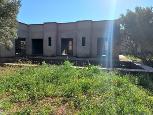 a building with the sun shining in front of it at immo in Aghmat