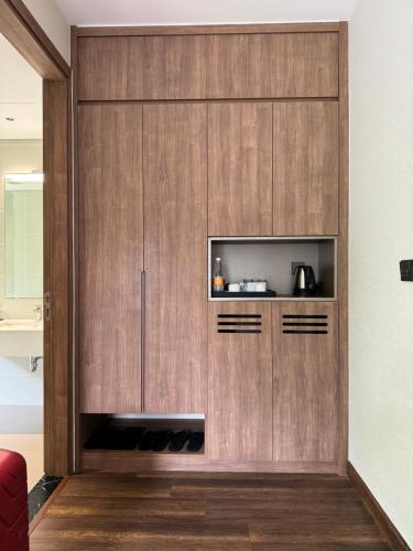 a wooden cabinet with a television in a living room at Sky villa on the beach in Cat Ba