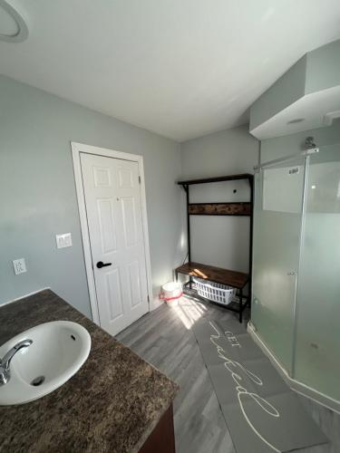 a bathroom with a sink and a shower at Modern Queen St Duplex 4BRs in Charlottetown