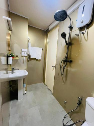 a bathroom with a shower and a sink and a shower at ZAN Lodge in Male City
