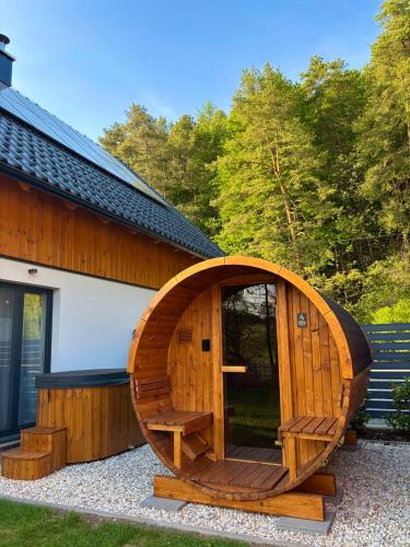 a wooden sauna next to a building at Chaty ForRest in Stará Turá