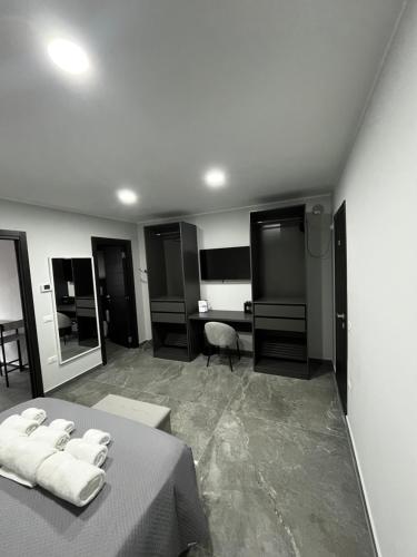 a bedroom with a bed with two white towels on it at Dimora Deluxe in San Severo