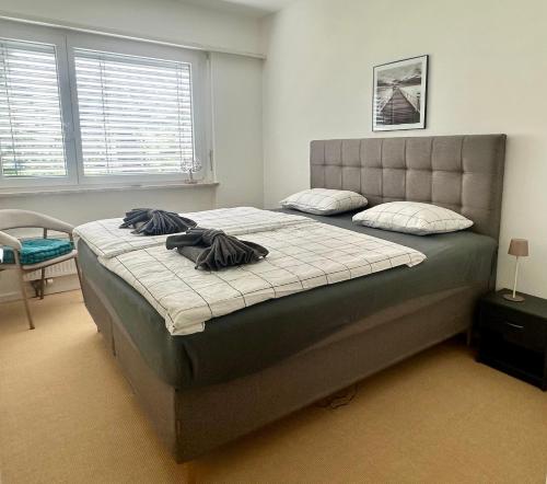 a bedroom with a large bed with two pillows on it at Ferienwohnung C06 in Orselina