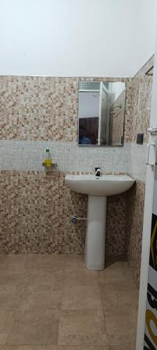 a bathroom with a sink and a mirror at MSM Surf Camp in Arugam Bay