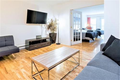 a living room with a couch and a coffee table at Charming Condo - Perfect for Visiting Quebec City in Quebec City