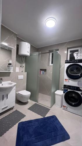 a bathroom with a toilet and a sink at Apartman Mešanović in Tuzla