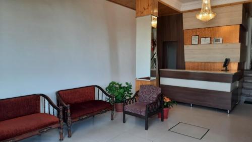 a waiting room with two chairs and a counter at Hotel Lords Regency - Connected to the Mall Road in Shimla