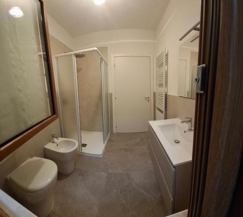 a bathroom with a shower and a toilet and a sink at Casa Lilli in Zogno