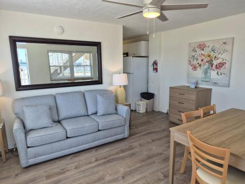 a living room with a couch and a table at Aquarius Oceanfront Inn in Wildwood