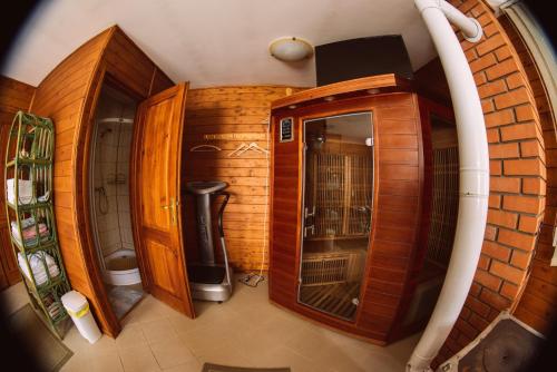 an overhead view of a bathroom with wooden cabinets at Flóra Apartmanok in Parádsasvár