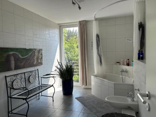 a bathroom with a sink and a tub and a toilet at House Susanne in Cologne