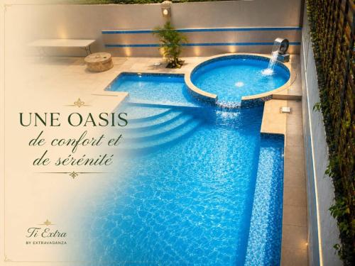 a swimming pool in a hotel with the words un oasis be caught at be at Hotel El Elyon Ti Extra in Terrier Rouge