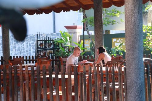 a man and a woman sitting at a table at Sumal Villa in Beruwala