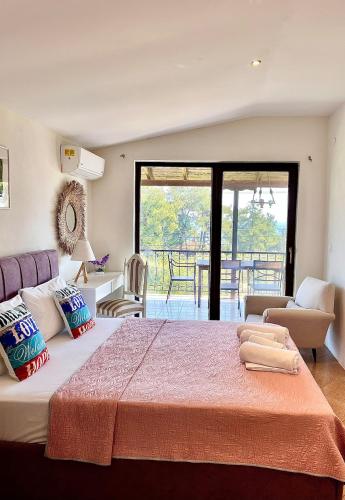 a bedroom with a large bed and a living room at green & blue villa in Glykadi