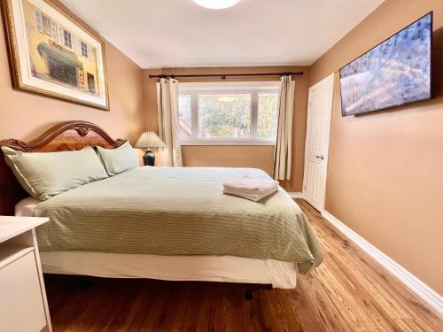 a small bedroom with a bed and a window at Renovated Rooms 10-min to Finch Subway Near Yonge St in Toronto
