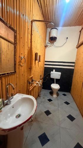 a bathroom with a sink and a toilet at Drona Farms in Bhundsi