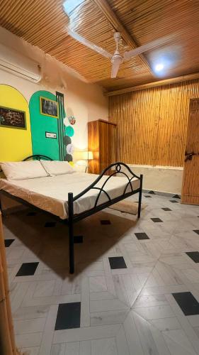 a bedroom with a bed in the middle of a room at Drona Farms in Bhundsi