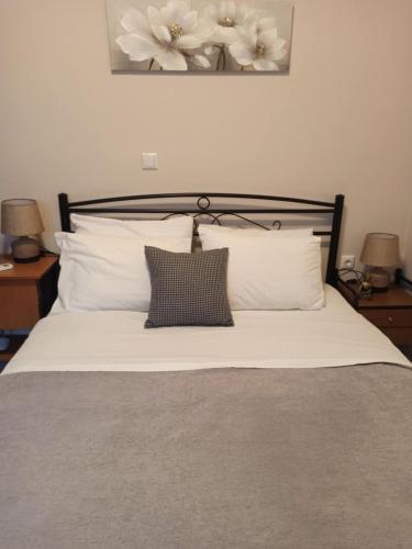 a bedroom with a bed with white pillows at Magenta in Igoumenitsa