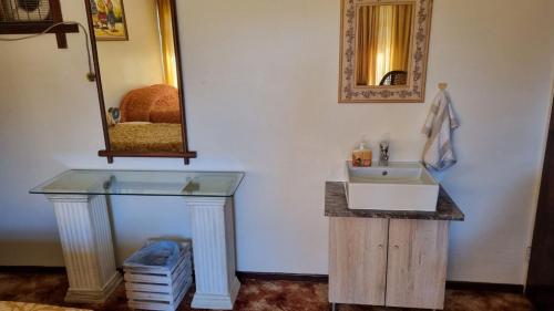 a bathroom with a sink and a mirror at Highway Haven in Stilfontein