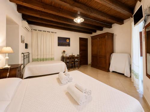 a bedroom with two beds with towels on them at L'Antica Torre Caralis Holiday in Cagliari