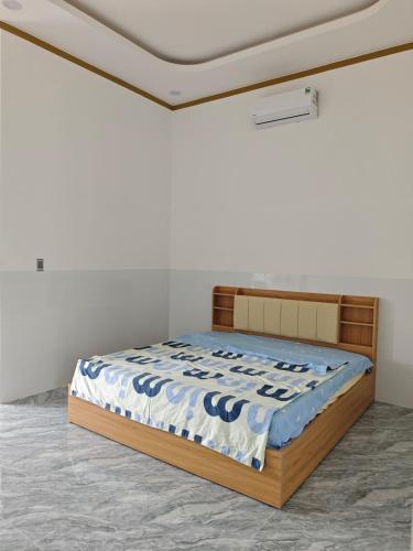 a bedroom with a bed in a white room at MAY homestay in Phú Khương