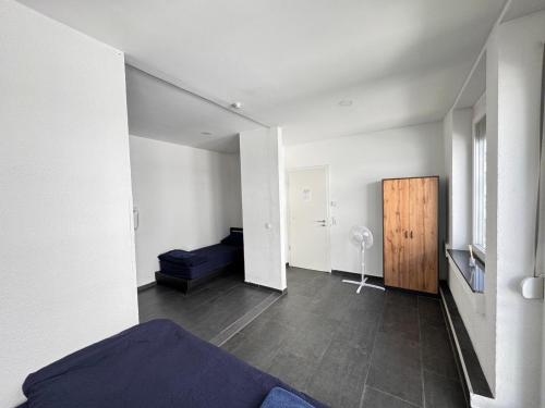 a bedroom with a bed and a room with a door at Marie Zimmer Zentral Bequem in Heilbronn