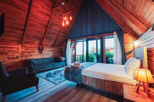 a bedroom with a bed and a couch in a room at Seyr-i Mavi Bungalow in Mavikent