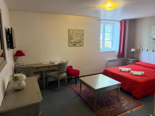 a bedroom with a bed and a desk and a table at HOTEL GALIMAR in Lamalou-les-Bains