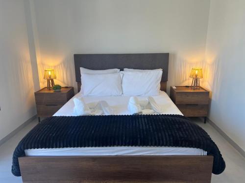 a bedroom with a large bed with two night stands at Urban Nest Corinth in Korinthos