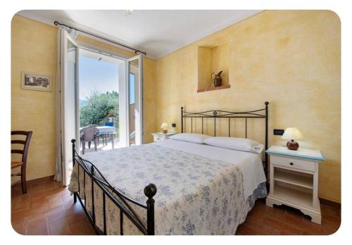 a bedroom with a large bed and a balcony at AGRITURISMO IL CARDO in Soiano del Lago
