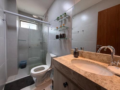 a bathroom with a shower and a toilet and a sink at dreams of the mountains in Bananeiras