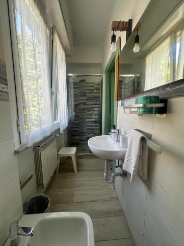 a bathroom with a sink and a toilet at Hotel Magnolia in Albenga