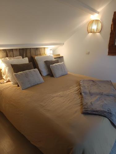a large bed with pillows on it in a room at Casa del Castel in Dreux