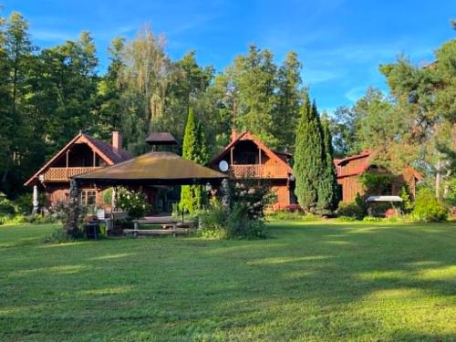 a house with a large lawn in front of it at Anglo-Polish Holidays in Chycina
